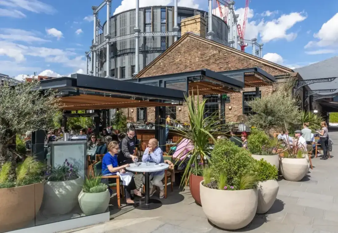 Diners at Parrillan, Coal Drops Yard, a restaurant bookable via the King's Cross and OUTRCH partnership.